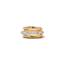 A stack of three rings on a plain white background. The top and bottom rings are wavy yellow gold bands, and the center ring is a slim silver band paved with small clear stones.