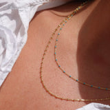 Necklace with turquoise beads and gold chain layer