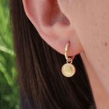 Gold huggy earrings with drop pendant