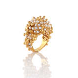 Gold ring with pearl-like stones on a white background
