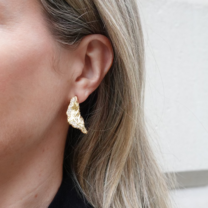 Gold earrings with textured petal design