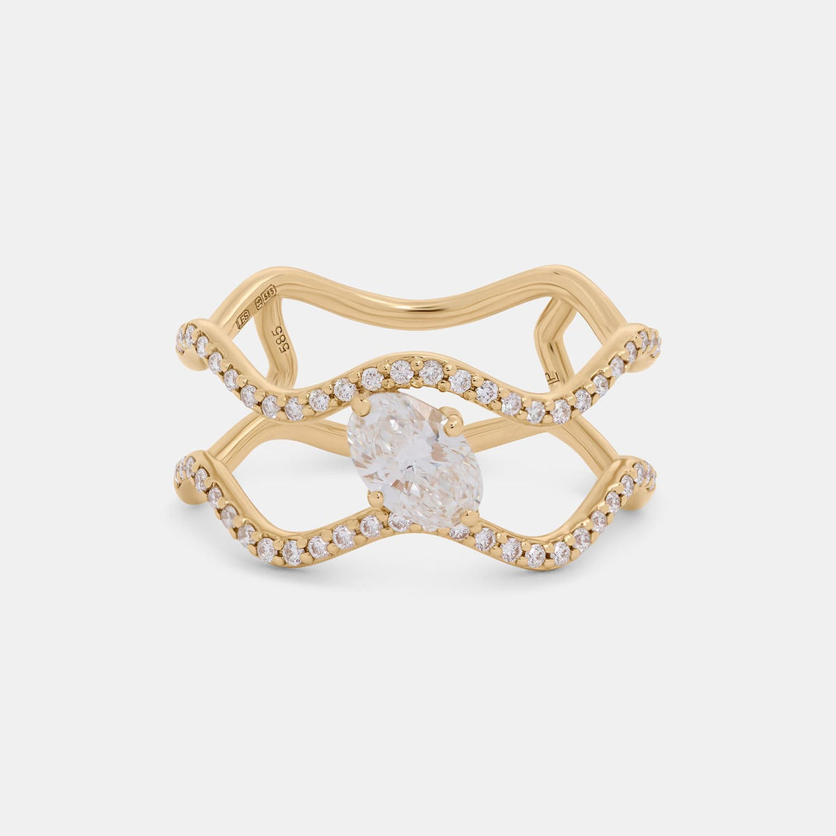 A gold ring with a wavy, openwork design, featuring a large oval center stone and small pavé-set clear stones along the curved bands, shown on a light gray background.