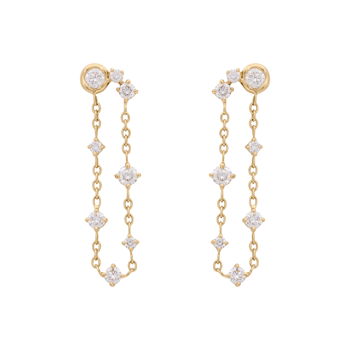 A pair of gold dangle earrings with clear gemstones, displayed against a solid white background.
