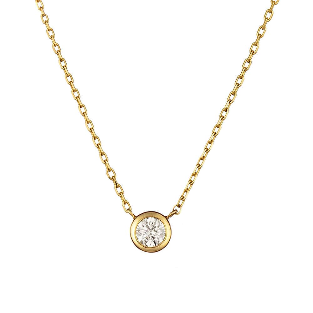 Gold necklace with a round diamond pendant on a white background