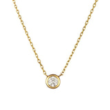 Gold necklace with a round diamond pendant on a white background