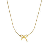 Gold bow-shaped pendant on a chain against a white background