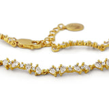 Gold bracelet with crystals on a white background