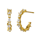 Gold hoop earrings with crystals on a white background