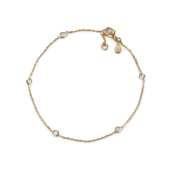 Gold bracelet with small diamonds on a white background