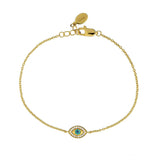 Gold bracelet with an evil eye charm on a white background