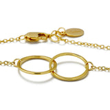 Gold bracelet with interlocking rings on a white background