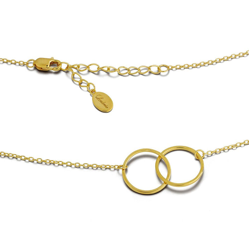 Gold necklace with interlocking rings on a white background