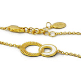 Gold bracelet with circular design on a white background