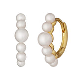 Gold hoop earrings with white pearls on a white background