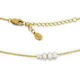 Gold necklace with pearl beads on a white background