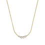 Gold necklace with three pearl beads on a white background