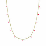 Gold necklace with pink enamel discs on a white background