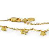 Gold bracelet with star charms on a white background