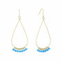 Gold teardrop earrings with blue beads on a white background