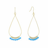 Gold teardrop earrings with blue beads on a white background