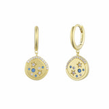 Gold earrings with celestial design on a white background